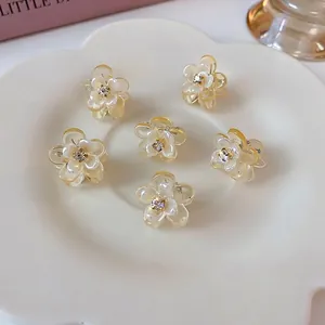 Set of 6 cute cream floral mini hair claws with rhinestones on a white tray