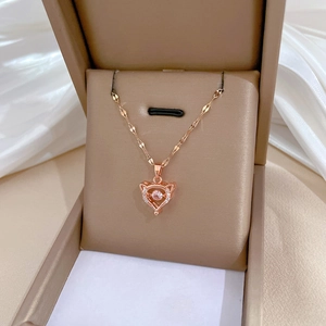 Detail of rose gold fox heart pendant with shimmering diamonds in a premium gift box