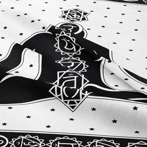 Detailed view of black and white Seven Chakras tapestry with soft fabric texture and symbols