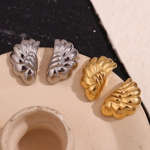 Macro detail of wave textured 18K gold and silver plated stainless steel stud earrings