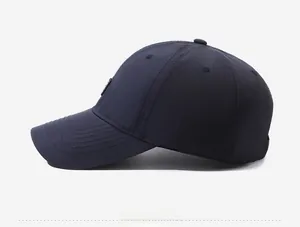 Side view of dark blue baseball cap with twill fabric and decorative brim stitching