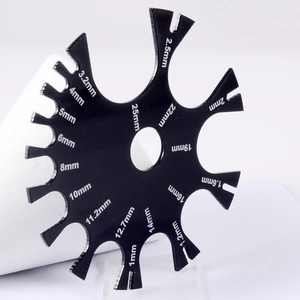 Black acrylic body piercing caliper with precise circular gauge for ear and needle measurements