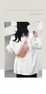Rear view of a stylish pink waterproof oxford waist bag worn across a person's back