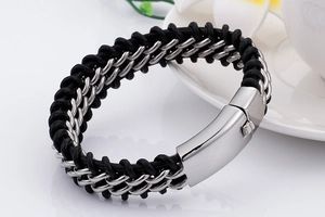 Macro shot of double-row black woven leather bracelet with silver stainless steel clasp