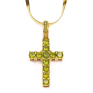 Detail of gold snake chain with cross pendant featuring eleven green round-cut zircons