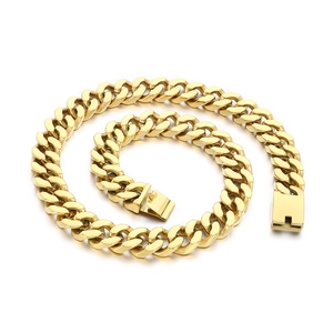 Polished gold-tone Cuban link chain necklace with secure box clasp on white background