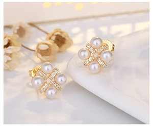 Detailed close-up of S925 silver flower earrings with white pearls and sparkling zircons