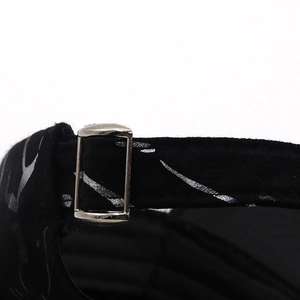 Detail of black fabric strap with silver metal buckle and silver foil texture