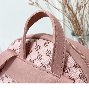 Close-up of pink crossbody bag showing detailed stitching and retro floral pattern