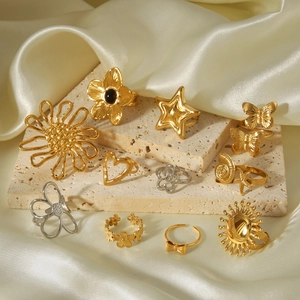 Macro view of gold and silver steel rings with floral heart and star patterns