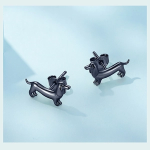 Close-up of S925 sterling silver dachshund stud earrings with engraved hallmark