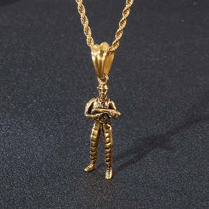 Detailed view of golden soldier pendant with rifle on a twisted rope chain necklace