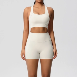Close-up of cream white yoga set with racerback bra and high-waisted shorts