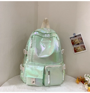 Detail view of water-resistant laser green backpack with iridescent finish and multi-pockets
