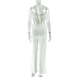 Rear view of white halter neck backless top and wide leg pants set on a mannequin
