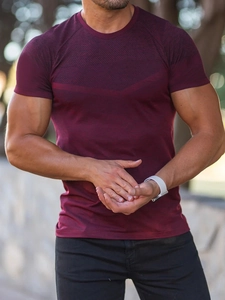 Close-up of burgundy athletic slim-fit short sleeve shirt with subtle geometric texture