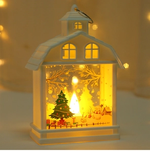 Detail of white Christmas lantern featuring a snowman and warm LED light miniature scene
