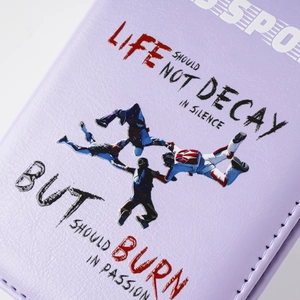 Detail of purple leather passport holder featuring printed athlete and motivational quote