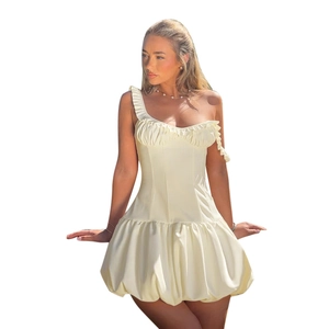 Asymmetric cream bubble hem mini dress with ruffled single shoulder strap and cinched waist