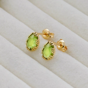Macro detail of pear-cut olive green gems set in 14k gold plated sterling silver studs