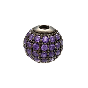 Macro detail of a spherical copper bead with micro-pave purple crystals for DIY jewelry making