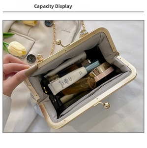 Top view of compact chain bag interior showing capacity with cosmetics and golden frame