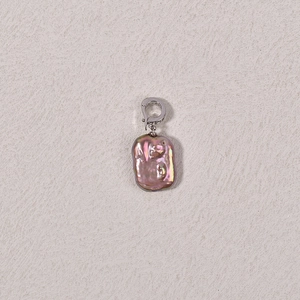Macro view of purple baroque pearl pendant with silver crystal-studded clasp