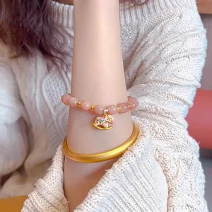 Pink sunstone beaded bracelet with gold rocking horse charm and matte gold bangle set