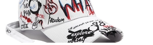 Close-up of white canvas baseball cap featuring artistic street style graffiti prints