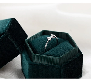 Elegant silver bow ring presented in a luxury dark green hexagonal velvet jewelry gift box