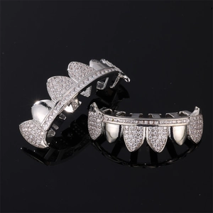 Hip hop silver grillz set with full sparkling diamonds on a black reflective background