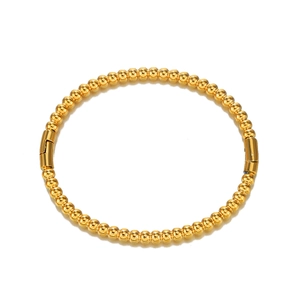 Polished gold beaded stainless steel bangle featuring a minimalist circular ball design