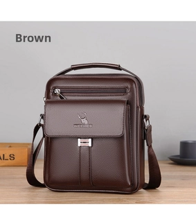 Detail of brown litchi pattern leather shoulder bag with handle on wooden table