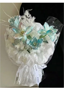 Close-up of artificial blue frosted tulips with white feather accents and snowflake wrap