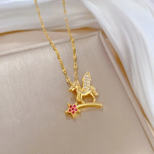 Elegant gold unicorn Pegasus necklace with red star pendant and crystal wings on silk