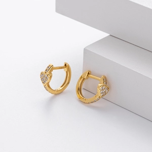 Detailed close-up of golden S925 sterling silver heart earrings with zircon micro-pave