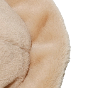 Close-up of the plush faux fur texture and wavy brim detail on a beige winter bucket hat
