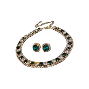 Elegant gold necklace and emerald earring set with sparkling crystal rhinestones