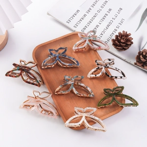 Elegant butterfly hair claws set in various acetate patterns with metallic accents