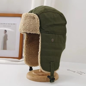 Close-up of winter pilot hat with army green canvas and warm faux lamb wool lining