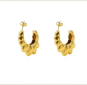Detailed view of 18K gold plated C-shape earrings with shell textured metallic finish