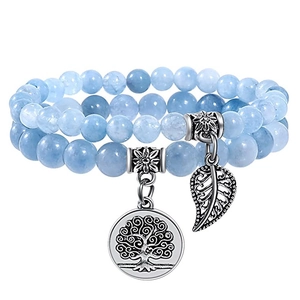 Blue beaded double-layer bracelet with tree of life and leaf pendants on white background