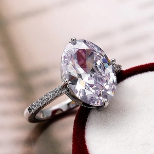 Close-up of large marquise-cut zircon ring in luxury red velvet box with pave diamonds