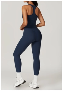 Detail of high-waisted yoga set in navy blue with racerback sports bra and leggings