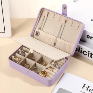Open purple leather jewelry box showing interior compartments for rings and necklaces
