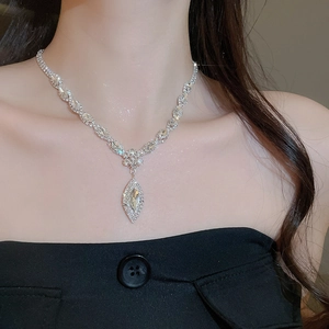 Detailed view of silver leaf water drop pendant necklace set with sparkling rhinestones
