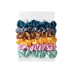 Set of 6 colorful satin scrunchies for women on a white display card minimalist style