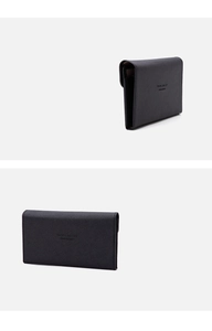 Close-up of black RFID travel wallet featuring cross-grain texture and travel engraving