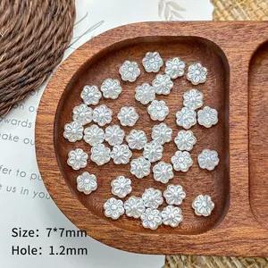 Macro shot of 7mm white flower-shaped acrylic pearls for DIY jewelry craft making