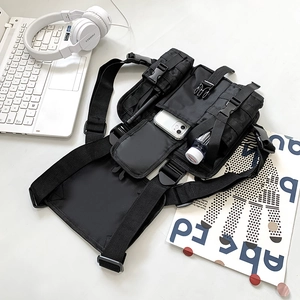Detail of tactical chest bag with multiple pockets, MOLLE system and breathable mesh back